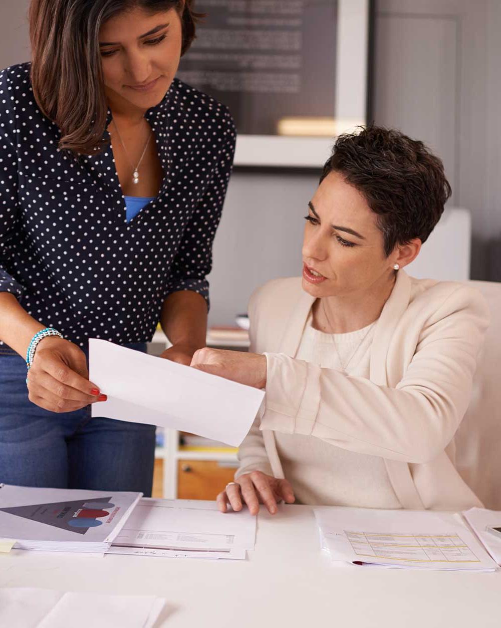 Coworkers looking over a document at work